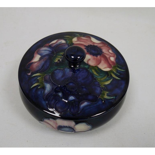 44 - Moorcroft lidded powder bowl with blue ground floral decoration, oblate, with paper label 'W Moorcro... 