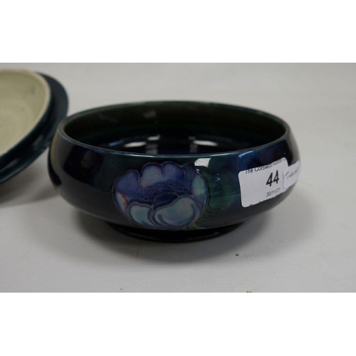 44 - Moorcroft lidded powder bowl with blue ground floral decoration, oblate, with paper label 'W Moorcro... 