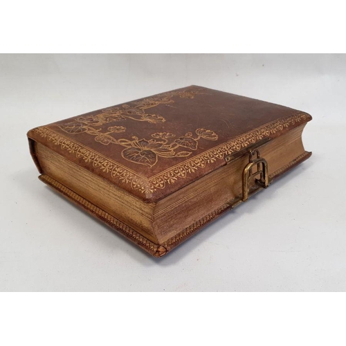 107 - Victorian tooled leather musical photograph album, the cover decorated with waterlilies, the interio... 