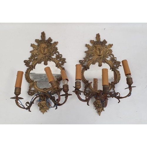 111 - Pair of three-branch girandole wall mirrors, the brass frames with mask decoration, 44cm high (2)