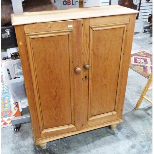 1116A - Late 19th/early 20th century pine two-door cabinet, the two panelled doors enclosing shelves, on tur... 