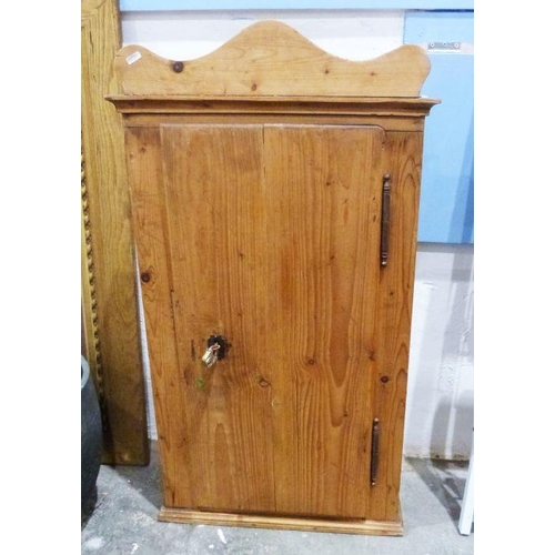 1117A - Vintage pine wall-hanging single door cabinet, the single door opening to reveal assorted shelves an... 