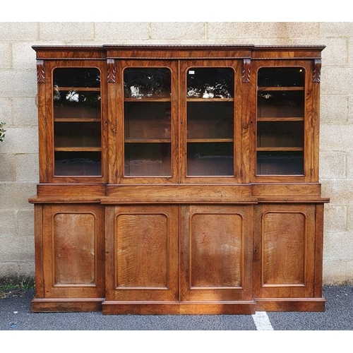 1135 - Victorian rosewood breakfront bookcase, frieze carved with beaded decoration over four glazed doors,... 