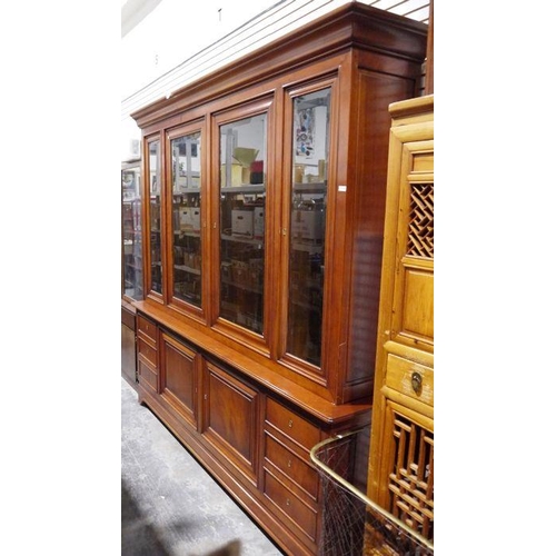 1140 - Large modern cherrywood bookcase with moulded cornice above four glazed doors enclosing shelves, the... 