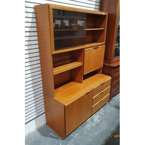 1141 - Mid century McIntosh teak lounge unit with sliding glass doors above fall and shelves, the base of c... 