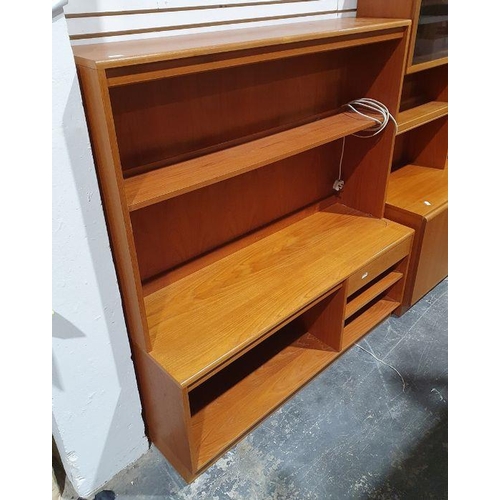 1142 - Mid century modern teak lounge unit with assorted shelves and drawer, on plinth base, 130cm x 140cm