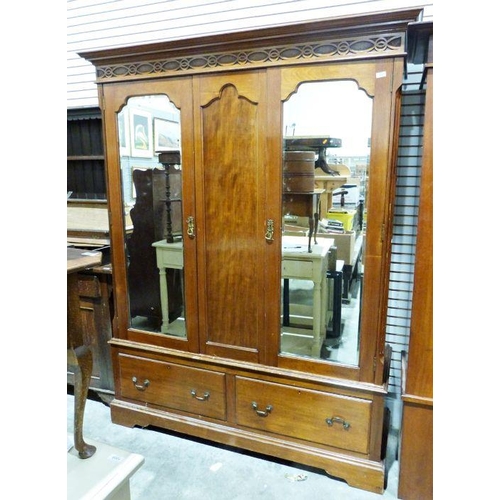 1144 - Early 20th century two-door mahogany wardrobe, the moulded cornice with blind fretwork carving, two ... 