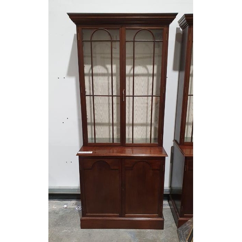 1148 - Pair of 20th century mahogany cabinets, the moulded cornices above astragal-glazed doors enclosing s... 