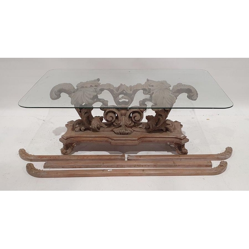 1160 - Coffee table, the rectangular glass top with rounded corners, on heavily carved and moulded base