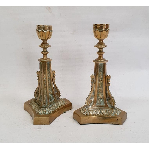 117 - Pair of brass candlesticks on triform bases with scroll and floral decoration, 22cm high (2)