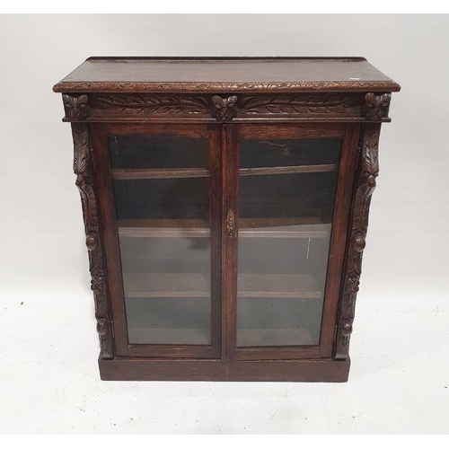 1227 - 20th century carved oak glazed bookcase on plinth base