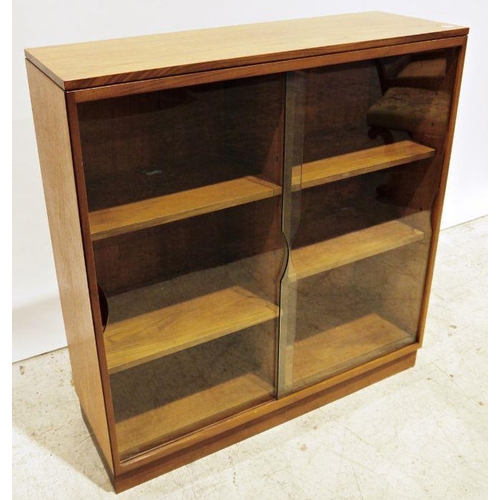 1252 - Mid-century modern teak bookcase with shaped sliding glass doors enclosing adjustable shelving, on p... 