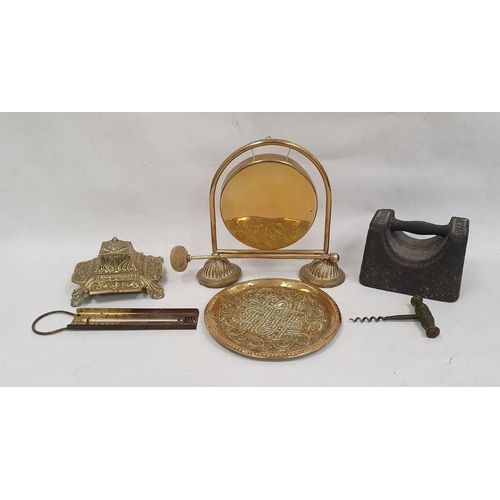 128 - Brass table gong, a brass inkwell of square form with scrolling floral decoration and various other ... 