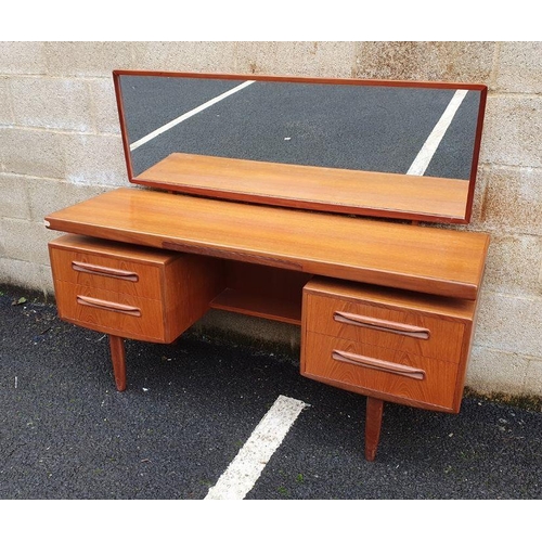 1295 - G-Plan teak mirrored dressing table, the rectangular surface with jewellery drawer, the base of four... 