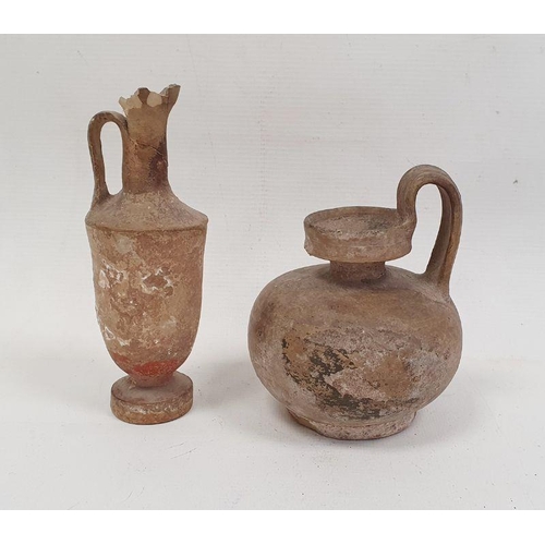 153 - Pottery vessel of circular form with loop handle, 12cm high and a pottery ewer with traces of painte... 