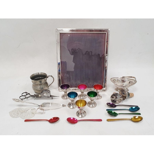 231 - Silver-coloured metal rectangular picture frame, a collection of metal eggcups with coloured interio... 