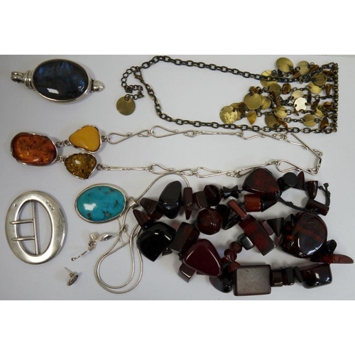 240 - Silver coloured wirework necklace set with three amber nuggets, a silver buckle of plain oval form a... 