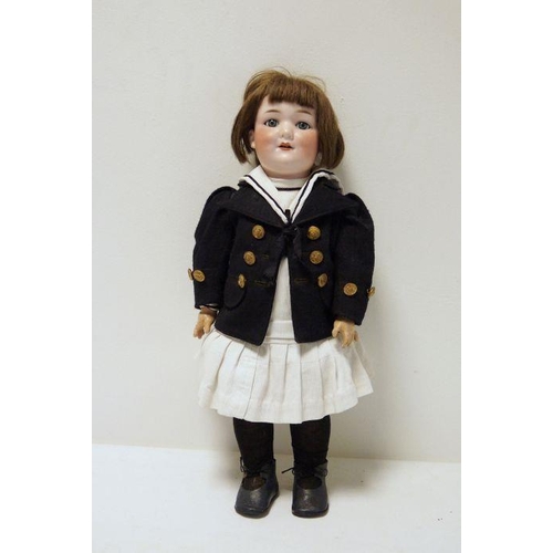 296 - Armand Marseille bisque headed doll no.560/8, in corduroy pinafore dress with navy sailor jacket hav... 