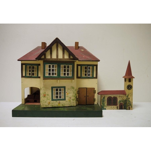 436 - A Triang painted doll's house, 42cm high with wooden painted clock tower (2)