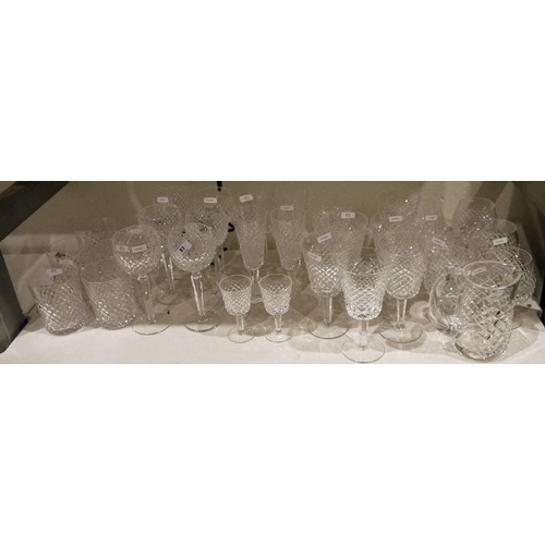 83 - Suite of Waterford cut drinking glasses, relief diamond patterned, 34 pieces viz:- six hock glasses,... 