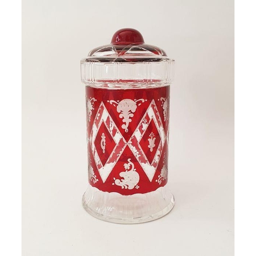 89 - An early 20th century Bohemian ruby red cut glass lidded jar with etched diamond and scrollwork deco... 