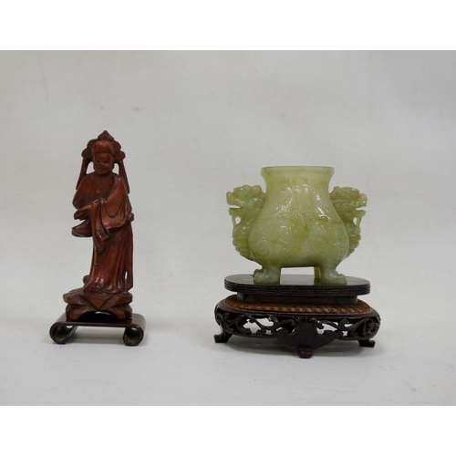 90 - Chinese jade censer, dog of Fo mask handles, and raised on four feet, together with a carved wood fi... 