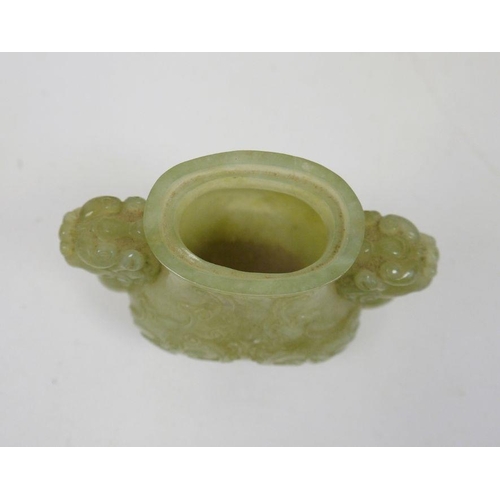 90 - Chinese jade censer, dog of Fo mask handles, and raised on four feet, together with a carved wood fi... 