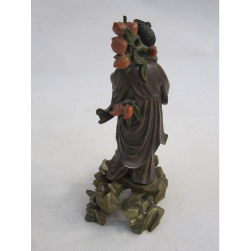 128 - Chinese carved and partly lacquered wood standing figure of a sage holding flowering lotus branch, t... 