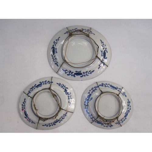 131 - Set of three Japanese imari porcelain dishes, oval and graduated, each centred by a kylin in iron-re... 