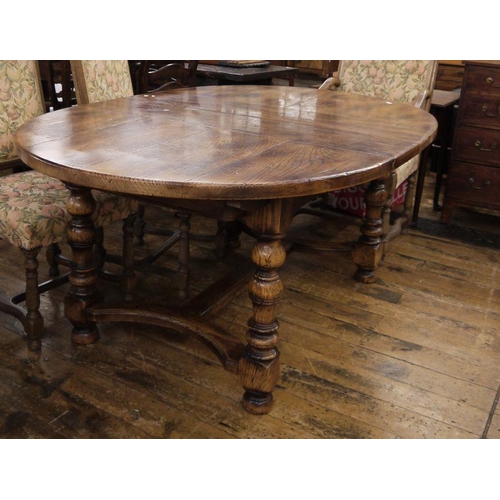 21 - Stained elm extending dining table of revived 17th century-style, the oval top with extra leaf and o... 