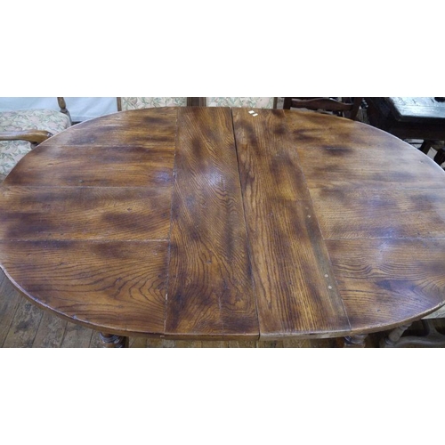 21 - Stained elm extending dining table of revived 17th century-style, the oval top with extra leaf and o... 