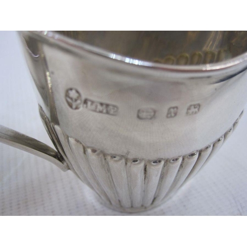 230 - Two silver small half gadrooned cream jugs of helmet form, differing dates and makers, 3oz (2)