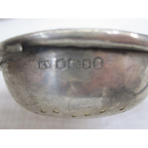 243 - Silver tea strainer with pierced handles, a silver  napkin ring and a small silver bowl, varying dat... 