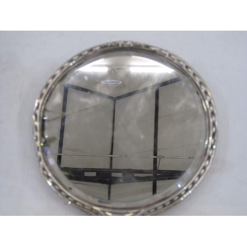 257 - Silver-backed hand mirror embossed floral swags, a small two-handled prize cup, an engine-turned sil... 