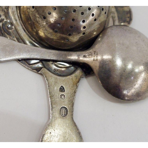 312 - Scandinavian silver-coloured metal tea strainer with scroll decoration and a Georg Jensen sterling e... 