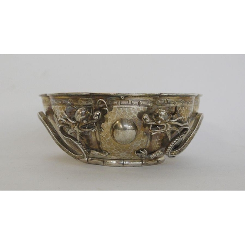 313 - Chinese white metal bowl of lobed circular form with hammered decoration and Greek key borders, with... 