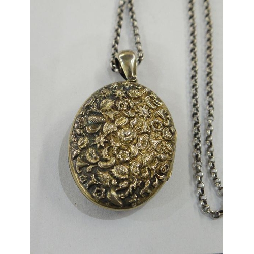 385 - Silver gilt-coloured metal locket on long silver-coloured metal chain