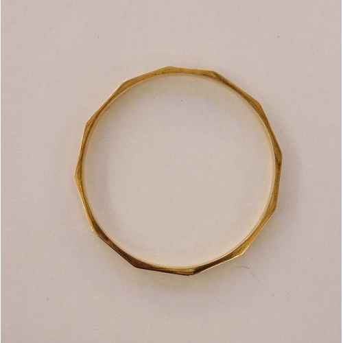 409 - 9ct gold slave bangle panelled with key-pattern engraving, 16.2g