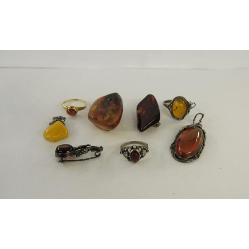 442 - Gold and amber cabochon ring, amber brooches, pendant and rings