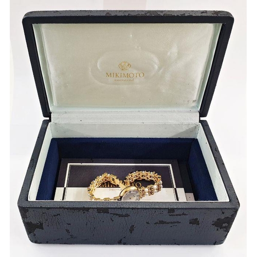 468 - Lady’s Mikimoto cultured pearl set rolled gold wristwatch, black onyx button, twin strap