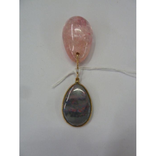 554 - Opal pendant in gold-coloured mount and a pink hardstone pendant (2)