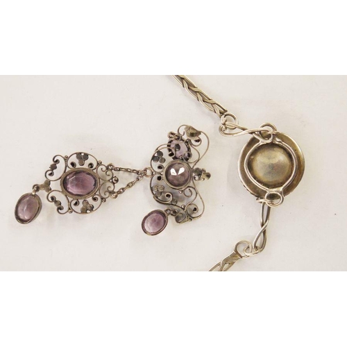 564 - White metal, amethyst and seedpearl pendant, the amethyst set within a scrolling wirework frame, 7.5... 