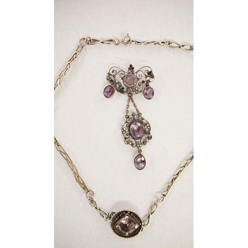 564 - White metal, amethyst and seedpearl pendant, the amethyst set within a scrolling wirework frame, 7.5... 