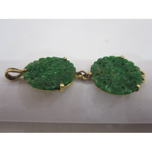 557 - Gold bar brooch set with oval jade plaque, marked 15ct, a gold-coloured pendant set with two pierced... 