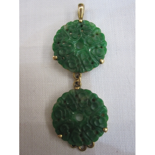 557 - Gold bar brooch set with oval jade plaque, marked 15ct, a gold-coloured pendant set with two pierced... 