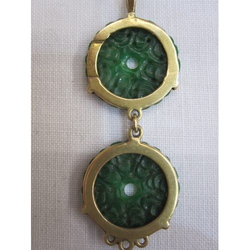 557 - Gold bar brooch set with oval jade plaque, marked 15ct, a gold-coloured pendant set with two pierced... 