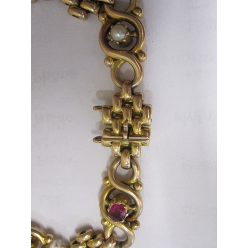 406 - 15ct gold, pearl and ruby-coloured stone ornate bracelet, trellis and scroll links set with three ol... 