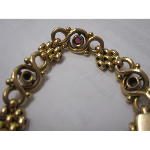 406 - 15ct gold, pearl and ruby-coloured stone ornate bracelet, trellis and scroll links set with three ol... 