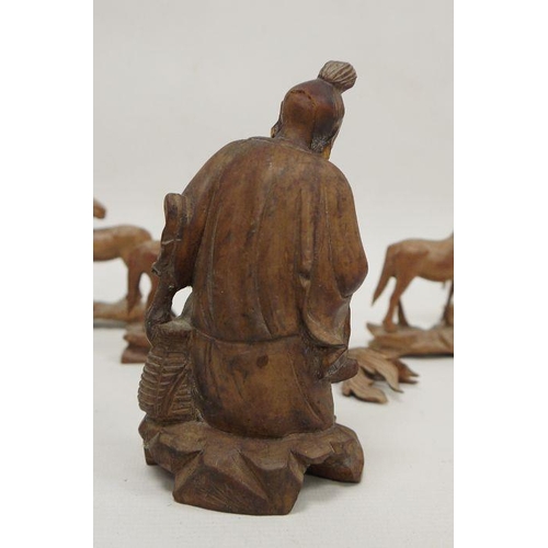 107 - Chinese carved hardwood figure, 20th century together with eight carved wood models of horses and a ... 