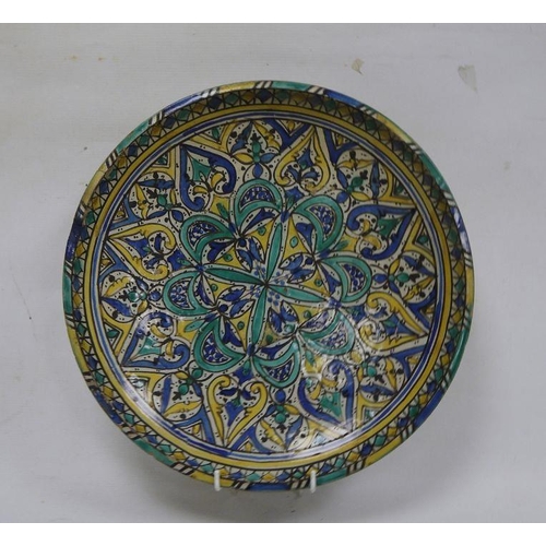 11 - Moroccan pottery charger, late 19th/early 20th century, painted in turquoise, blue and yellow with r... 